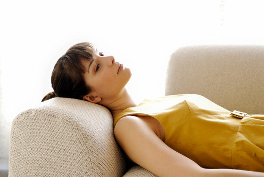 Woman lying down on sofa
